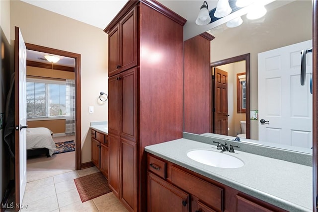 bathroom with tile patterned flooring, vanity, and toilet