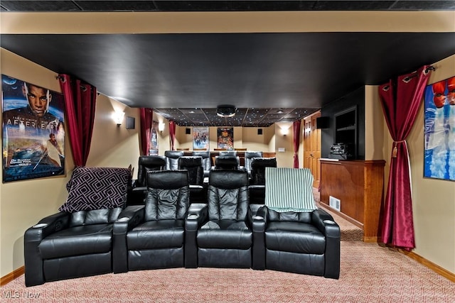 carpeted cinema room with bar