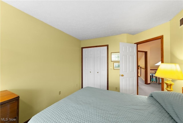 bedroom featuring light colored carpet and a closet