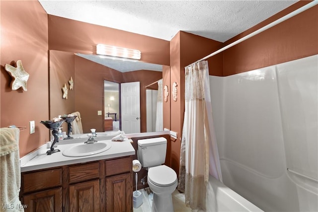 full bathroom with vanity, toilet, a textured ceiling, and shower / bath combo with shower curtain