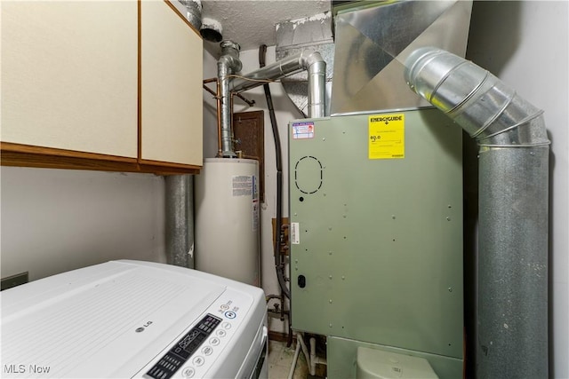 utilities featuring washer / dryer, heating unit, and gas water heater