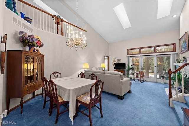 dining area with carpet flooring, an inviting chandelier, high vaulted ceiling, and a skylight