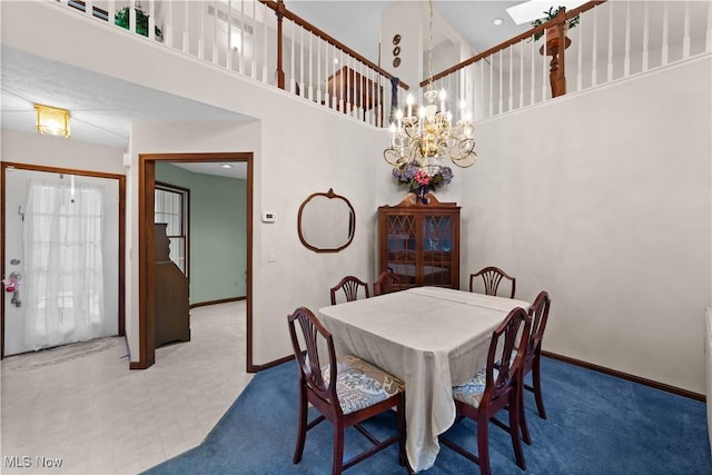 dining room featuring a chandelier and a high ceiling