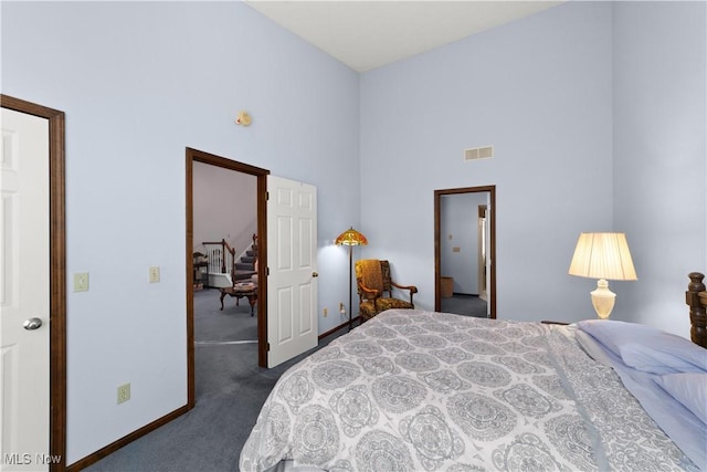 carpeted bedroom featuring a high ceiling