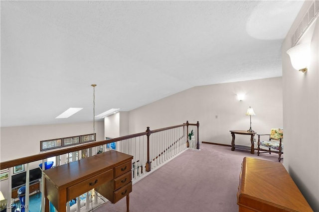 interior space with lofted ceiling with skylight and carpet floors