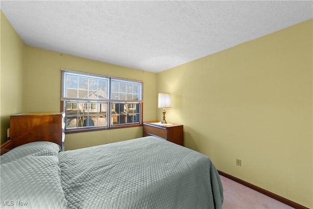 carpeted bedroom featuring a textured ceiling