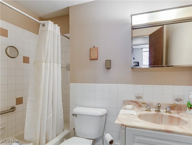 full bathroom featuring shower / tub combo with curtain, vanity, toilet, and tile walls