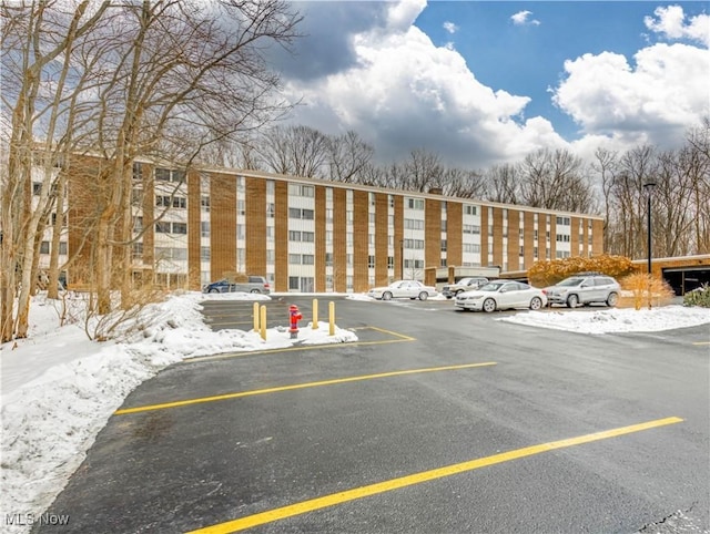 view of snow covered parking area