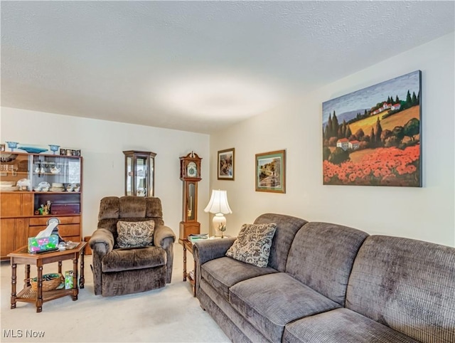 living room with light carpet and a textured ceiling