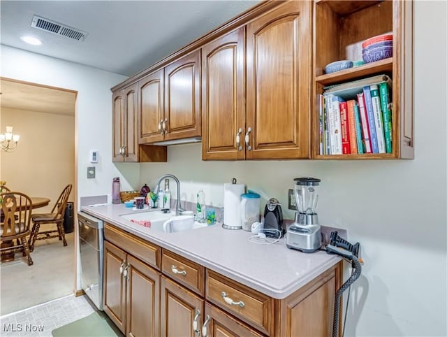 kitchen featuring dishwasher, sink, and a chandelier