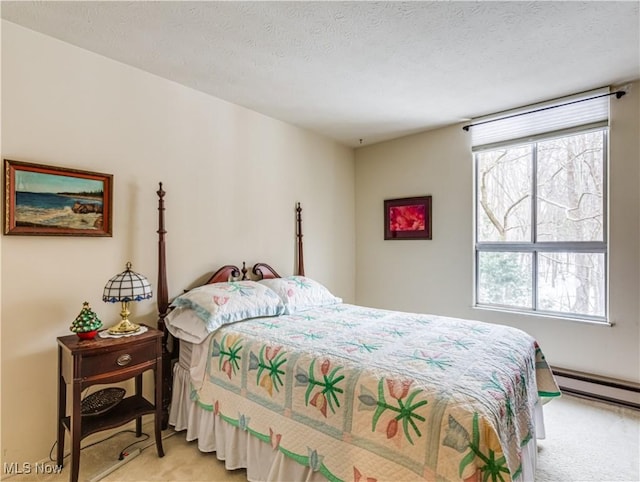 bedroom featuring multiple windows, light colored carpet, a textured ceiling, and baseboard heating