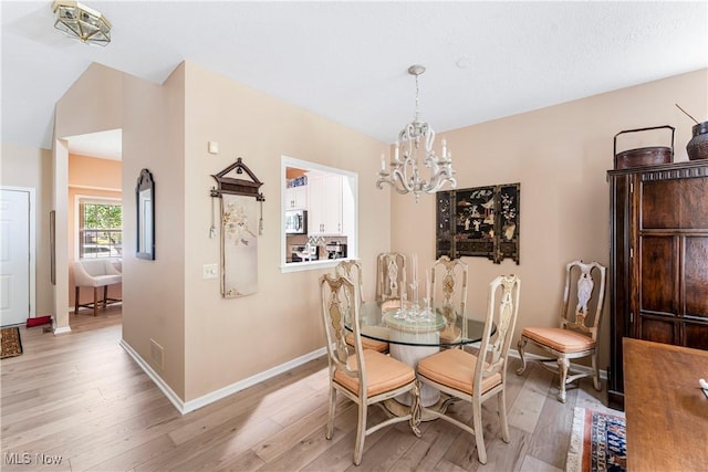 dining space featuring a notable chandelier and light hardwood / wood-style flooring