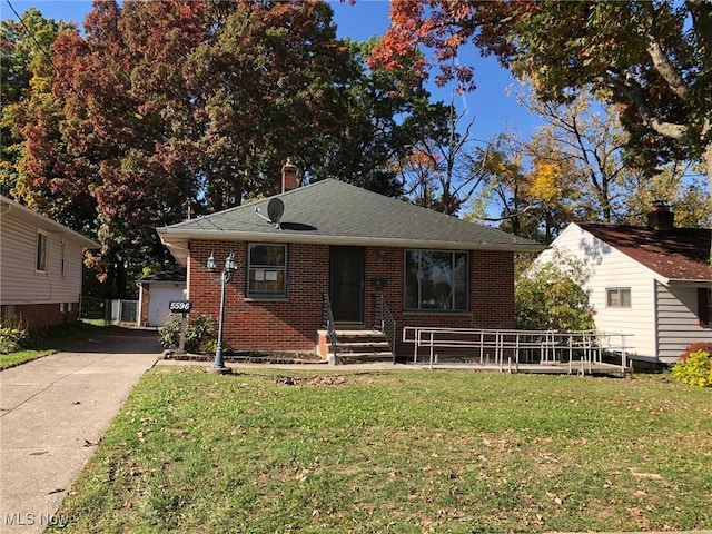 bungalow with a garage and a front yard