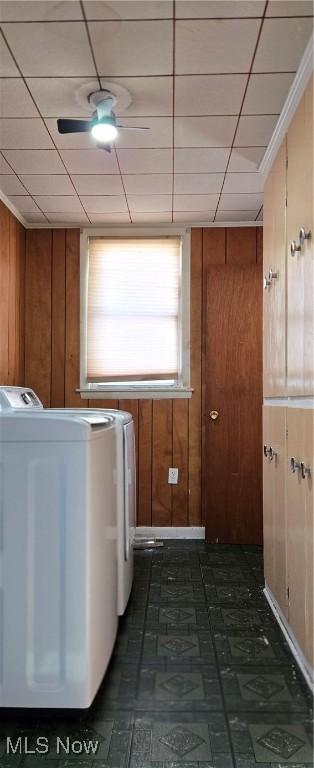 washroom featuring independent washer and dryer and wood walls