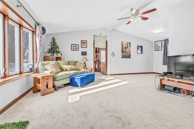 carpeted living room with ceiling fan and lofted ceiling with beams