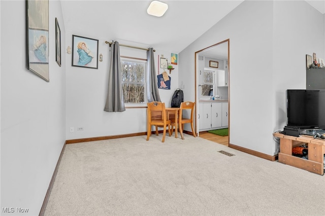 office featuring lofted ceiling and light carpet