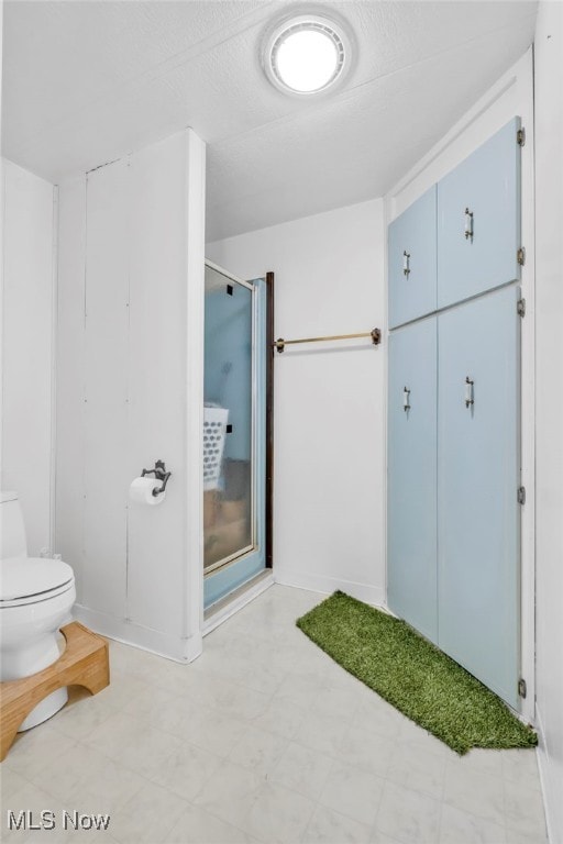 bathroom with toilet and walk in shower