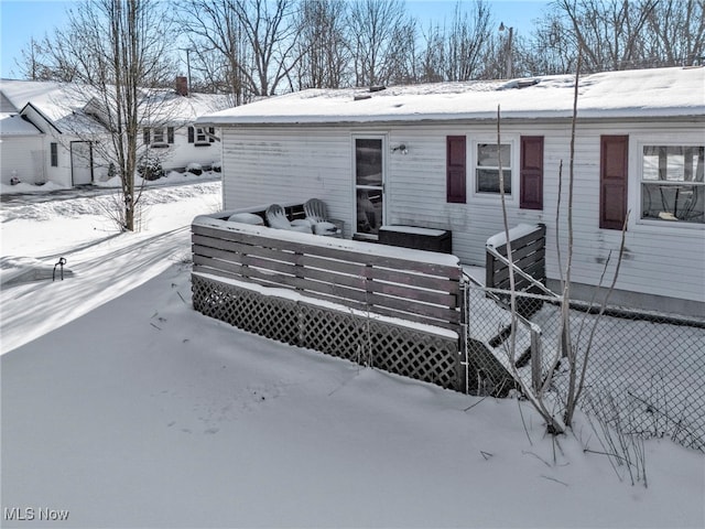 view of snow covered rear of property