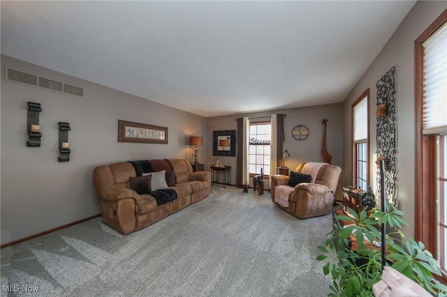 carpeted living room featuring baseboards and visible vents