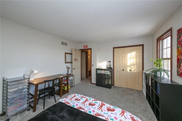 carpeted bedroom with a closet