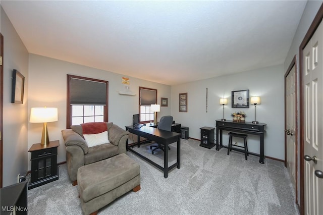 carpeted office featuring baseboards