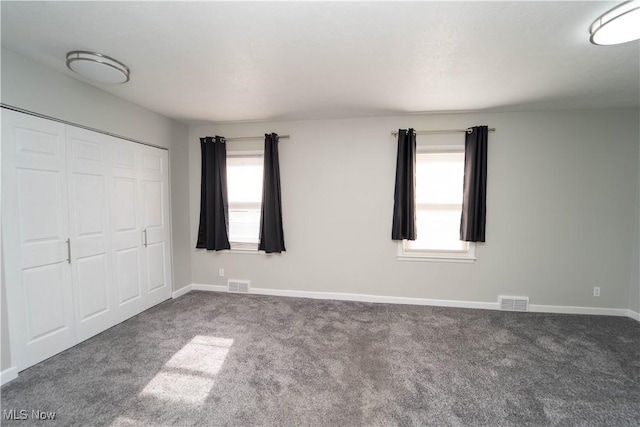 unfurnished bedroom with a closet and carpet