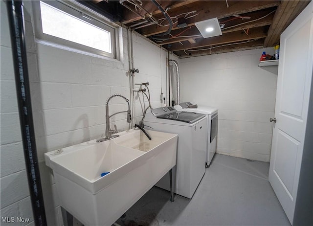 clothes washing area with washer and dryer and sink