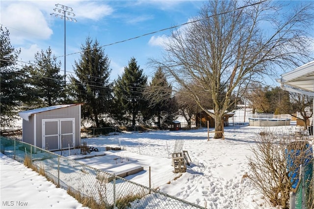 snowy yard with a storage unit