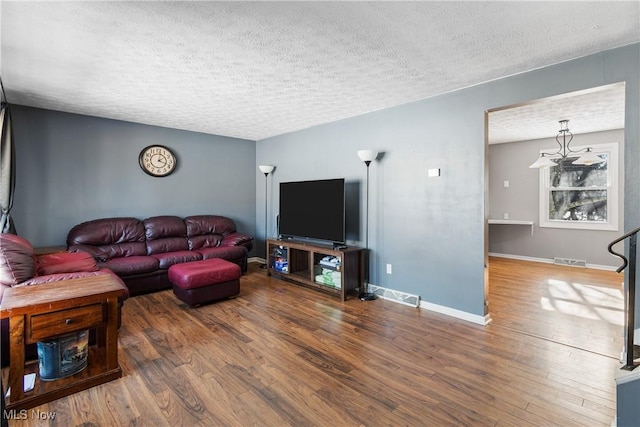 living room with hardwood / wood-style floors and a textured ceiling