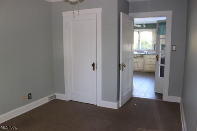 unfurnished bedroom featuring dark tile patterned floors