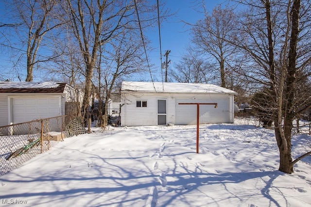 exterior space featuring a garage and an outbuilding