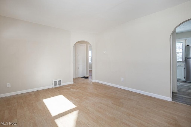 unfurnished room with light hardwood / wood-style floors