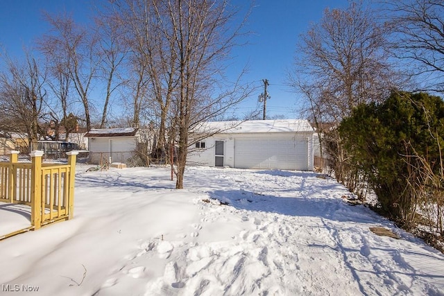 view of front of house featuring a garage and an outdoor structure