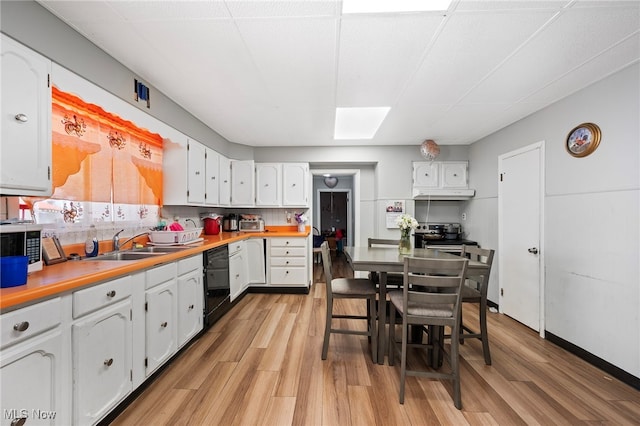 kitchen featuring tasteful backsplash, white cabinetry, dishwasher, and light hardwood / wood-style flooring