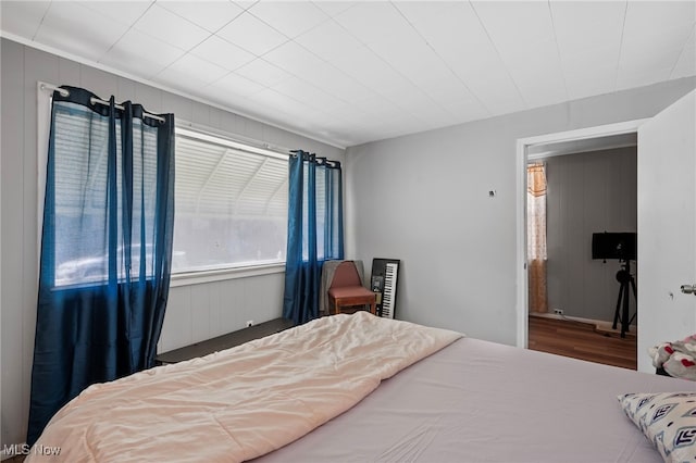 bedroom with wood walls