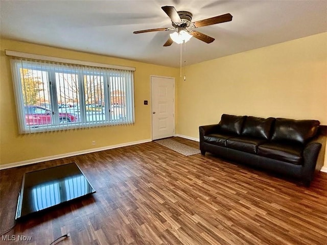 living room with hardwood / wood-style floors, a wealth of natural light, and ceiling fan