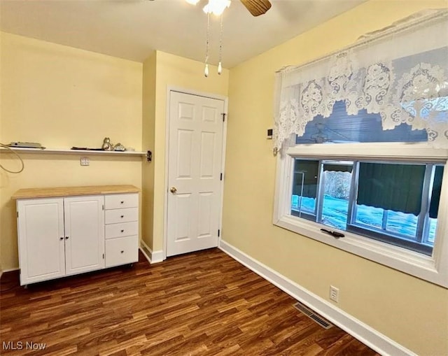 unfurnished bedroom with dark hardwood / wood-style flooring and ceiling fan