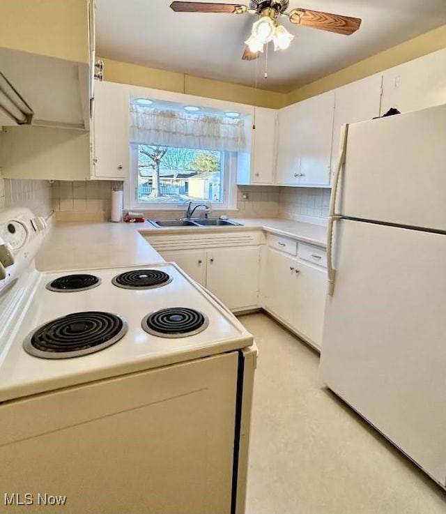 kitchen featuring white cabinetry, sink, decorative backsplash, ceiling fan, and white appliances