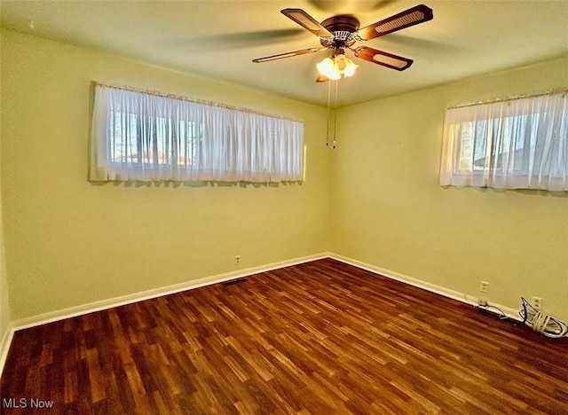 empty room featuring wood-type flooring and ceiling fan