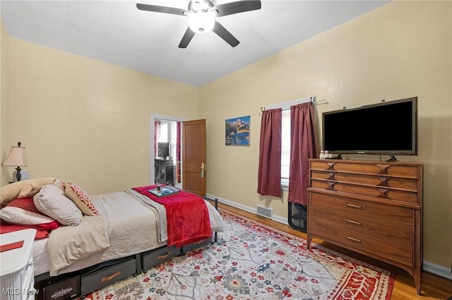 bedroom with ceiling fan and light hardwood / wood-style floors