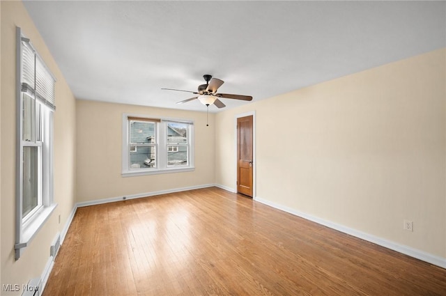 empty room with ceiling fan and light hardwood / wood-style floors