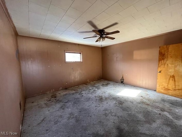 empty room featuring ceiling fan and carpet floors