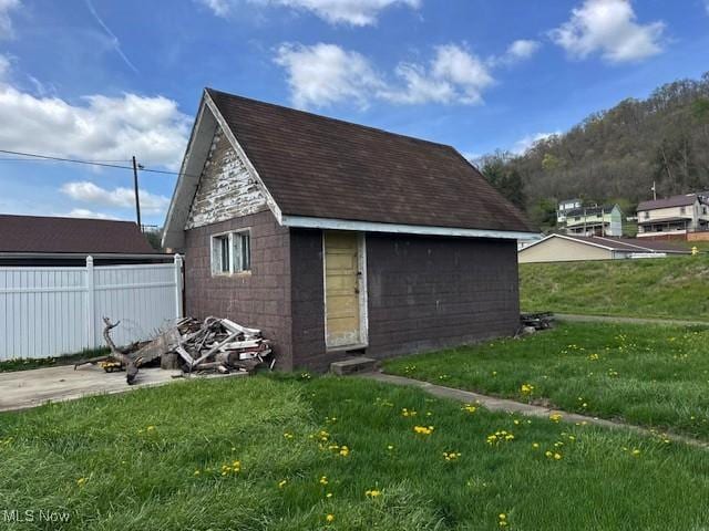 view of outbuilding with fence and an outdoor structure