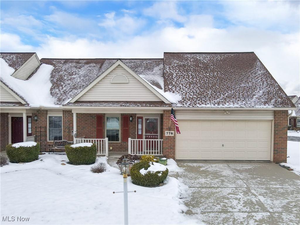 view of front of home featuring a porch and a garage