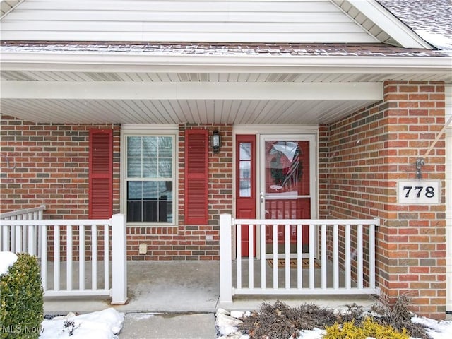 view of snow covered property entrance