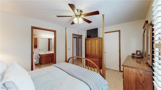 bedroom with ensuite bath and ceiling fan