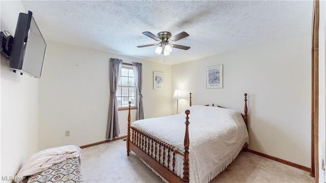 carpeted bedroom featuring a textured ceiling and ceiling fan