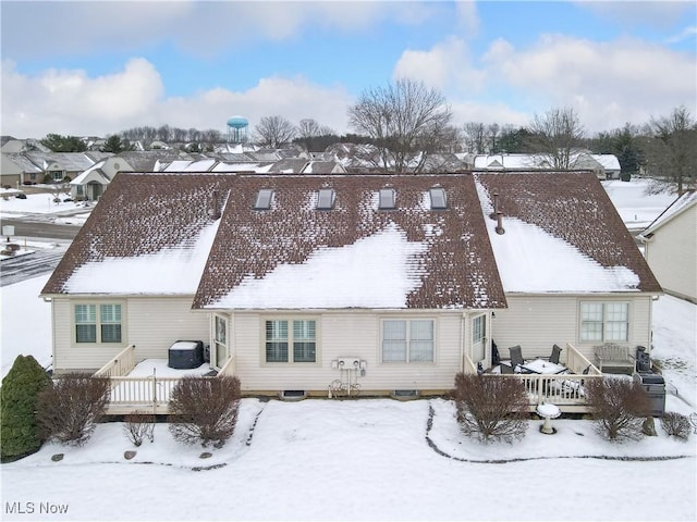 snow covered property with a wooden deck