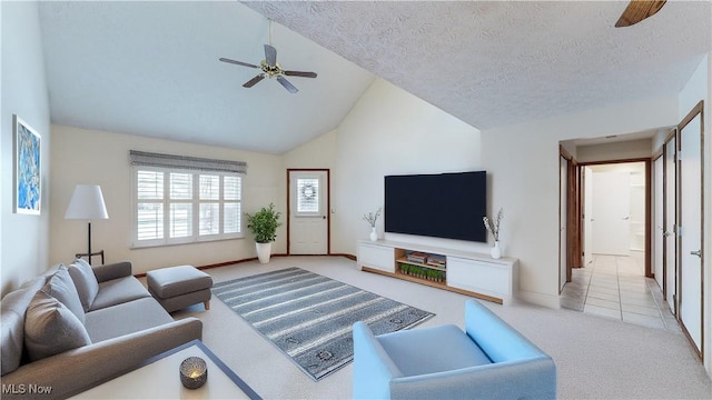 carpeted living room featuring ceiling fan, lofted ceiling, and a textured ceiling