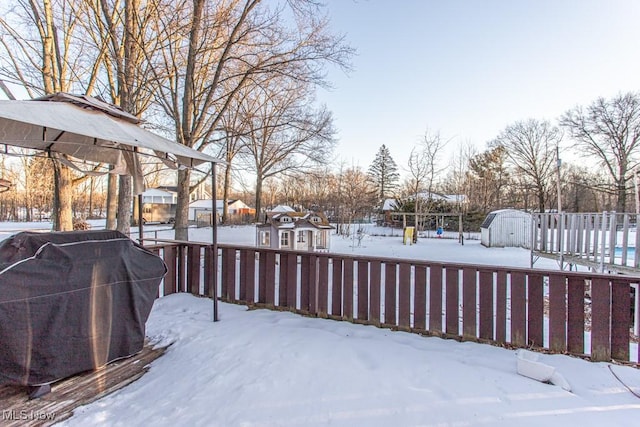 yard layered in snow with a deck